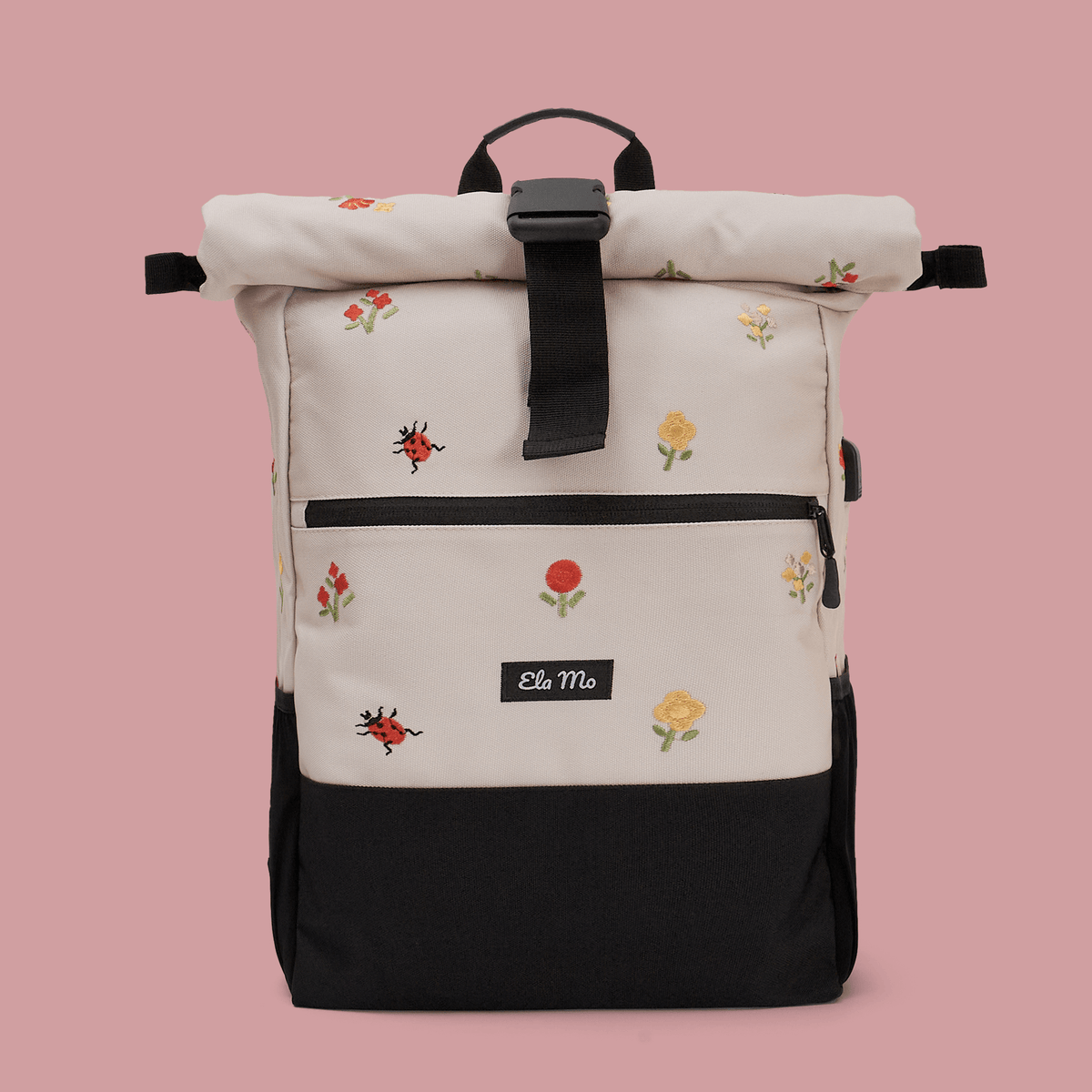 Ela Mo™ Rolltop Rucksack | Embroidery Edition Losy. Ein Rucksack auf rosa Hintergrund mit Herstellerlogo in der Mitte.